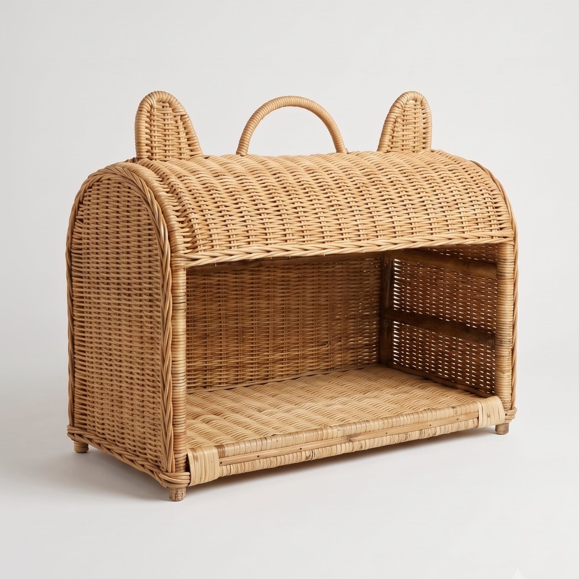 A natural woven rattan pet carrier with a hinged lid, cat ears on top, a top carry handle, and an open front compartment, shown on a light gray background.
