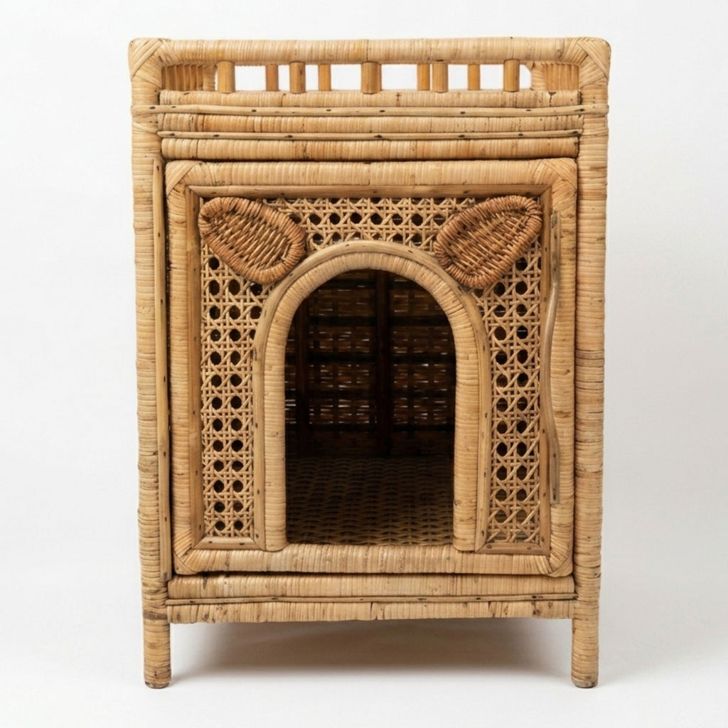 A natural rattan pet house with an arched entryway, woven cane panels, and ear details on the front, shown against a plain white background.