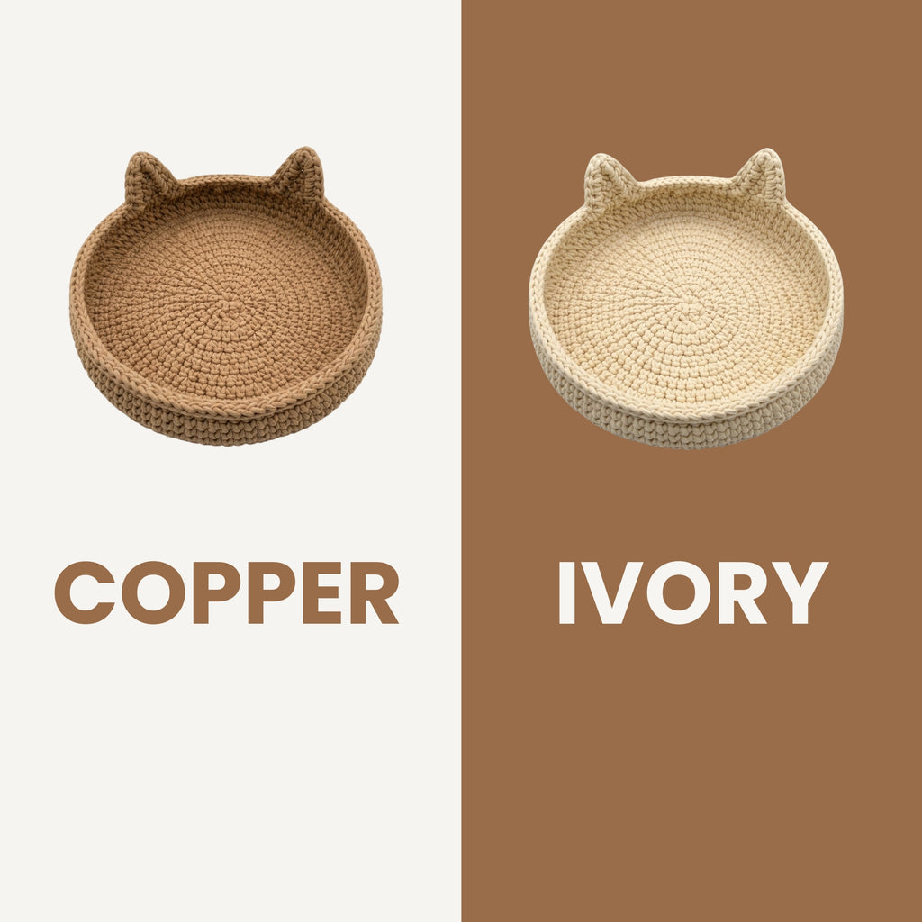 Two crocheted cat-ear tray baskets shown side by side on a split cream and brown background, labeled COPPER on the left and IVORY on the right.